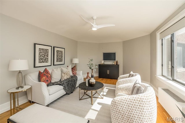 410 N Newstead Ave Unit 6W, Saint Louis, MO 63108 - living area with radiator heating unit, light wood-style flooring, ceiling fan, and baseboards