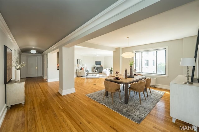 410 N Newstead Ave Unit 6W, Saint Louis, MO 63108 - dining area featuring light wood-style floors, baseboards, crown molding, and radiator heating unit