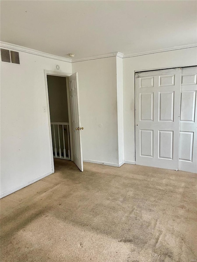 1290 Hodiamont Ave Unit B2, Saint Louis, MO 63112 - unfurnished bedroom with ornamental molding, carpet flooring, baseboards, and a closet