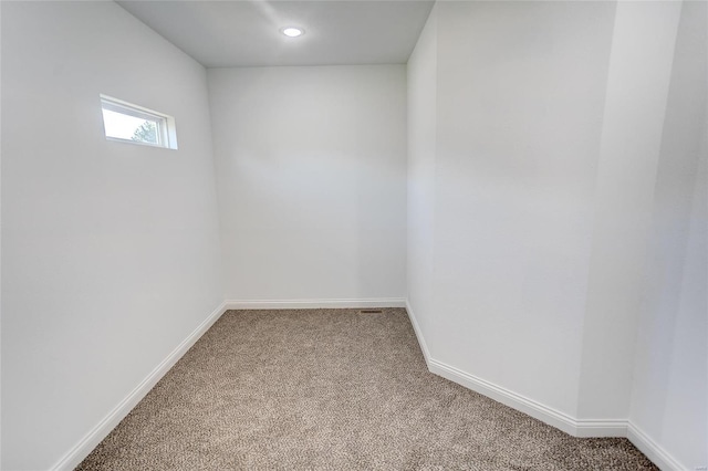 carpeted empty room with baseboards and recessed lighting