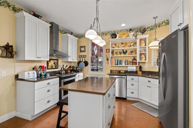 15 Mill St, Elsah, IL 62028 - kitchen featuring stainless steel appliances, wall chimney range hood, dark countertops, open shelves, and recessed lighting