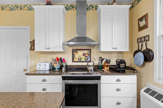 15 Mill St, Elsah, IL 62028 - kitchen with stainless steel electric range, wall chimney range hood, backsplash, dark stone countertops, and white cabinetry