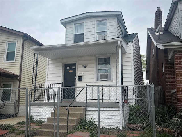view of front of property featuring a porch, a gate, and a fenced front yard