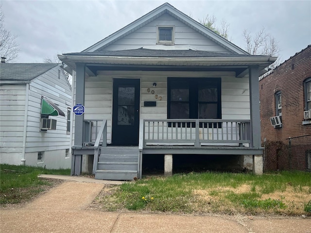 view of front of property with covered porch and cooling unit