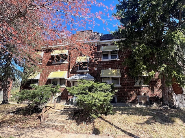back of house with brick siding