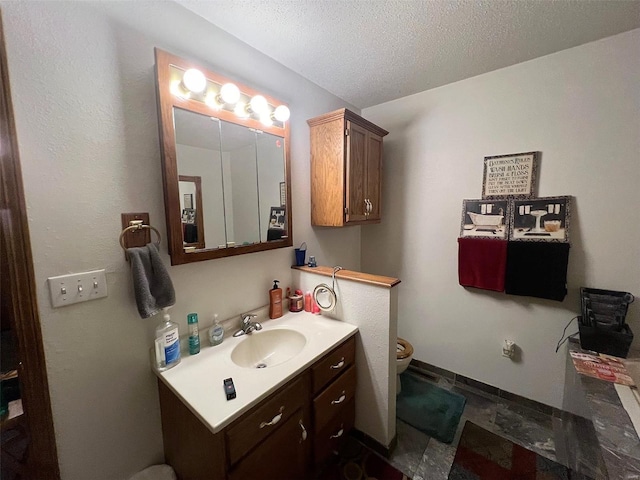 429 N Kennedy Blvd, Vandalia, IL 62471 - bathroom featuring vanity, toilet, a textured ceiling, and baseboards