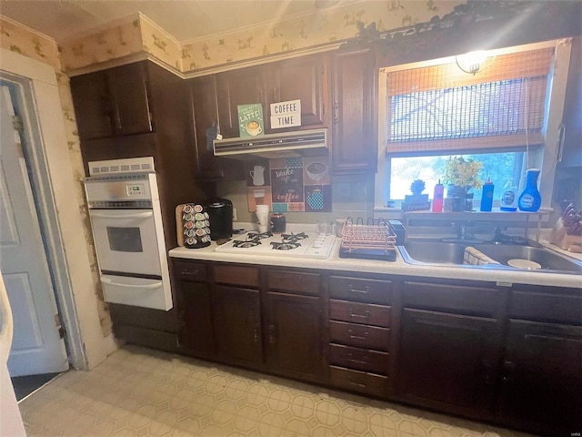 429 N Kennedy Blvd, Vandalia, IL 62471 - kitchen with a warming drawer, white appliances, a sink, light countertops, and under cabinet range hood