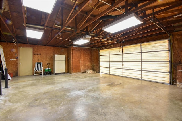 garage with freestanding refrigerator and a garage door opener