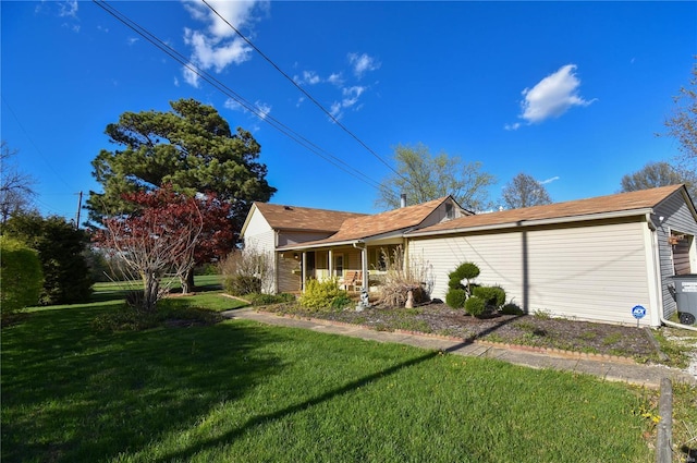 view of side of home featuring a lawn and covered porch
