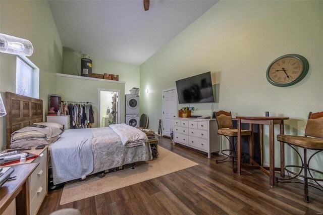 29455 State Highway Ac, Lebanon, MO 65536 - bedroom featuring stacked washing machine and dryer, high vaulted ceiling, and wood finished floors