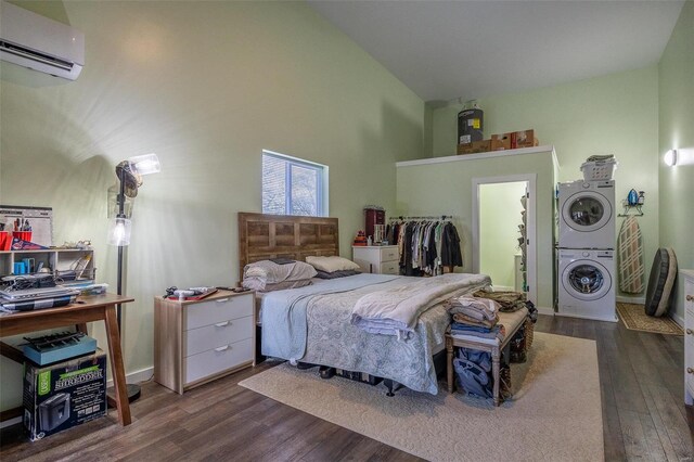 29455 State Highway Ac, Lebanon, MO 65536 - bedroom with a wall mounted AC, stacked washing machine and dryer, dark wood-style floors, and high vaulted ceiling