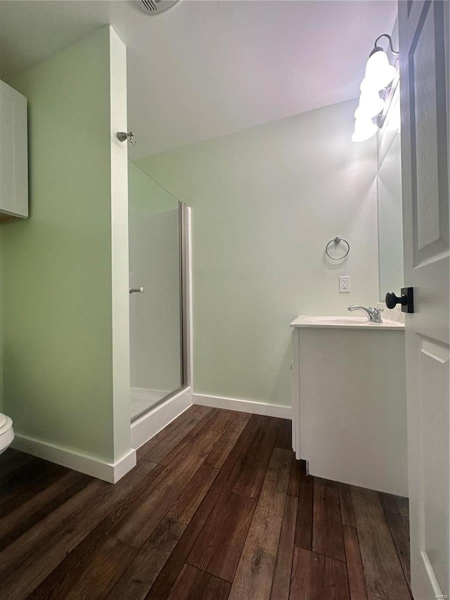 29455 State Highway Ac, Lebanon, MO 65536 - bathroom with hardwood / wood-style flooring, a shower with door, vanity, and baseboards
