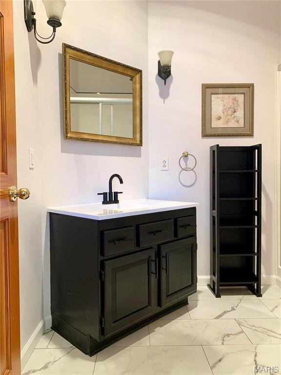 24613 Shady Oak Pl, Perry, MO 63462 - bathroom featuring marble finish flooring, baseboards, and vanity