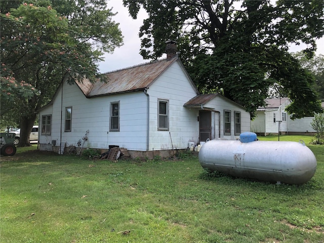 119 W 6th St, Gerald, MO 63037 - view of property exterior featuring a chimney and a yard