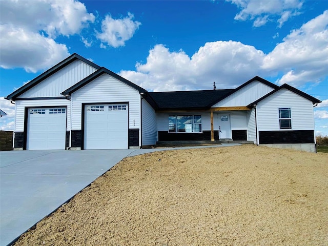 view of front of home with an attached garage and concrete driveway