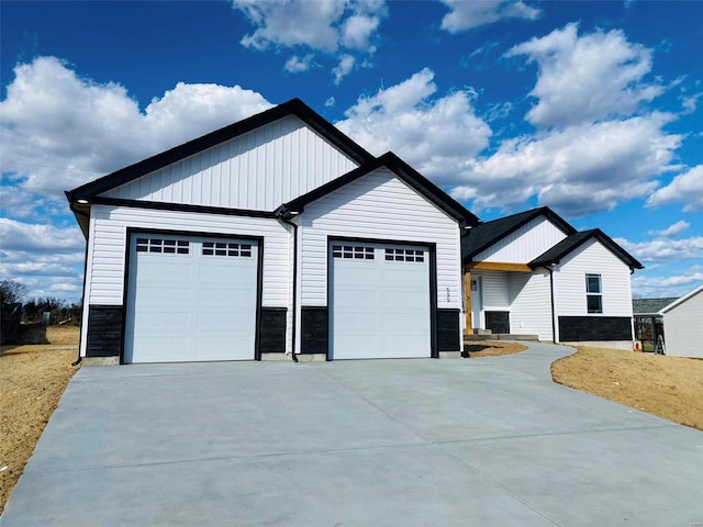 view of front of home with stone siding and driveway
