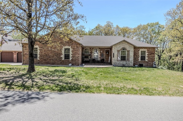 25625 Open Ridge Ln, Lebanon, MO 65536 - ranch-style house with a front lawn, a garage, concrete driveway, brick siding, and a shingled roof