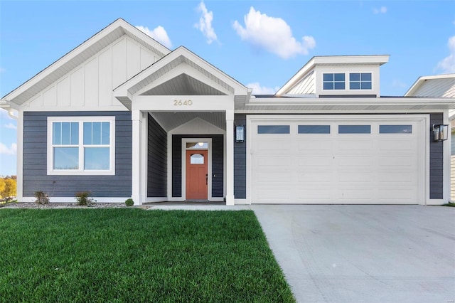 2640 Walden Blvd, Cape Girardeau, MO 63701 - view of front facade with a front yard, a garage, board and batten siding, and driveway
