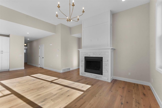 2640 Walden Blvd, Cape Girardeau, MO 63701 - unfurnished living room with light wood-style floors, a chandelier, baseboards, a fireplace, and recessed lighting