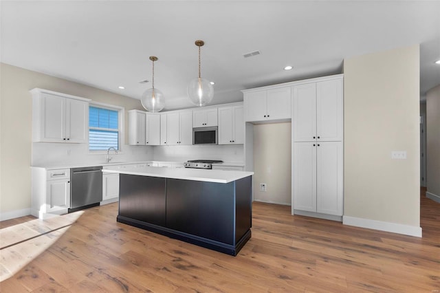 2640 Walden Blvd, Cape Girardeau, MO 63701 - kitchen with stainless steel appliances, white cabinetry, a center island, recessed lighting, and light countertops