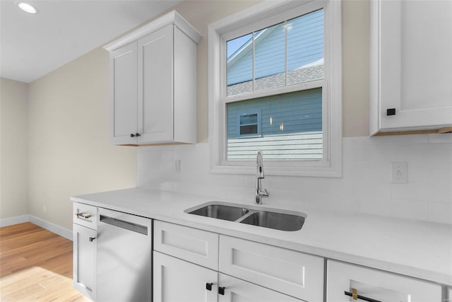 2640 Walden Blvd, Cape Girardeau, MO 63701 - kitchen with dishwasher, a sink, light countertops, baseboards, and light wood-style floors