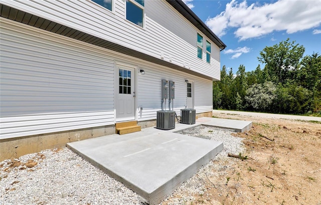 view of patio with cooling unit and entry steps