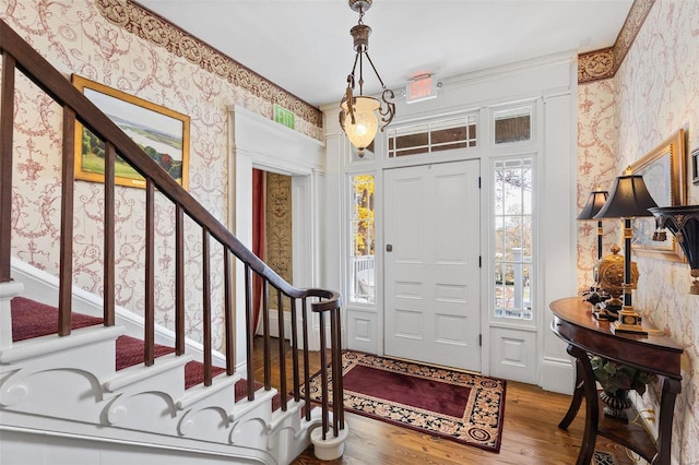 813 S 4th St, Clarksville, MO 63336 - foyer featuring wallpapered walls, wood finished floors, and stairs