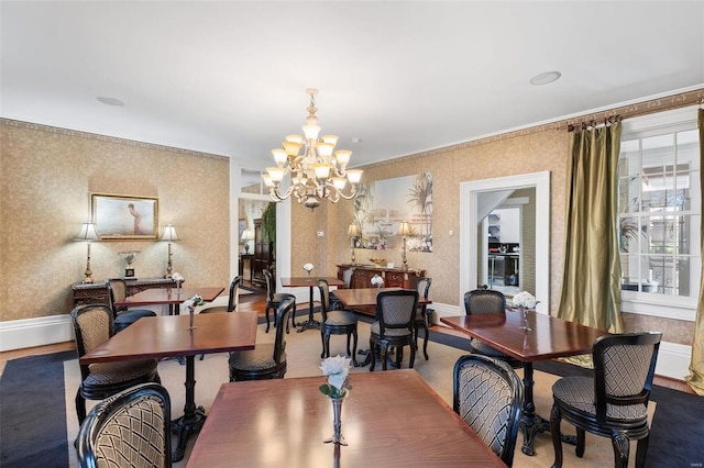 813 S 4th St, Clarksville, MO 63336 - dining area with a chandelier, wallpapered walls, baseboards, and ornamental molding