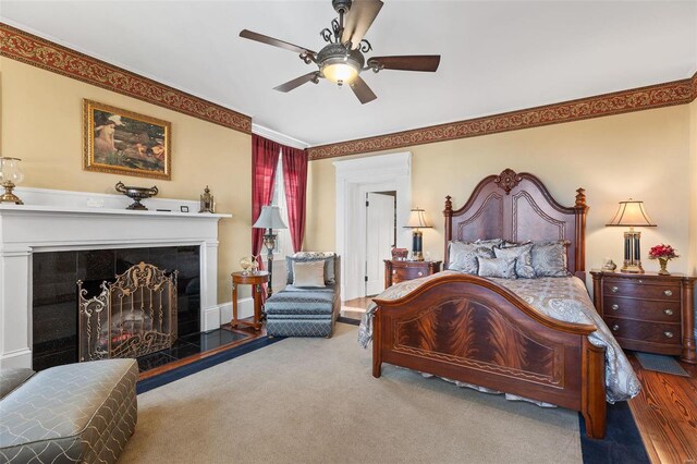 813 S 4th St, Clarksville, MO 63336 - bedroom featuring crown molding, a tiled fireplace, carpet floors, a ceiling fan, and baseboards