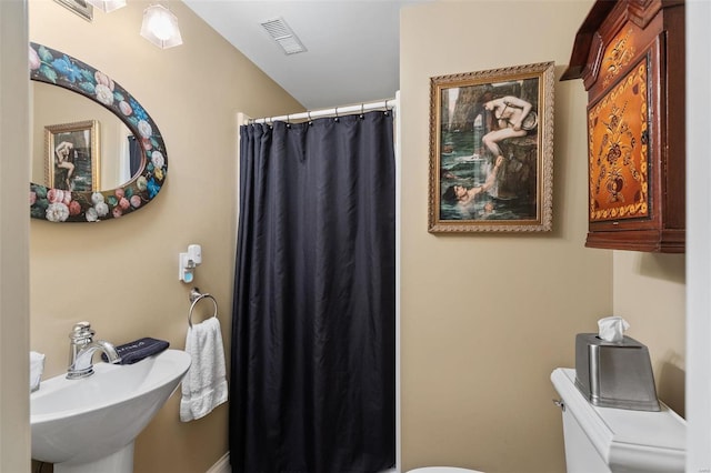 813 S 4th St, Clarksville, MO 63336 - bathroom featuring a sink, toilet, and a shower with shower curtain