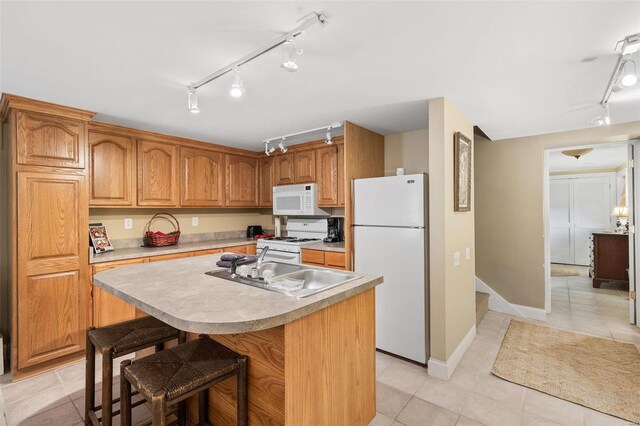 813 S 4th St, Clarksville, MO 63336 - kitchen featuring white appliances, track lighting, a sink, light countertops, and light tile patterned floors