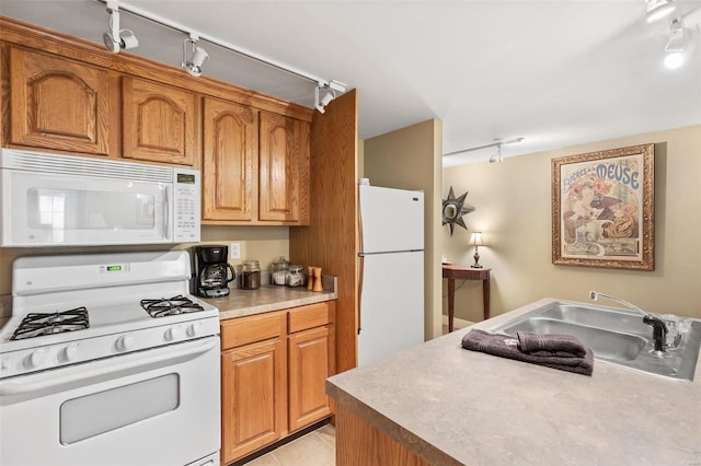 813 S 4th St, Clarksville, MO 63336 - kitchen featuring white appliances, track lighting, a sink, light countertops, and brown cabinets
