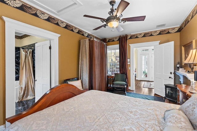 813 S 4th St, Clarksville, MO 63336 - bedroom with wood finished floors, ceiling fan, a closet, and attic access