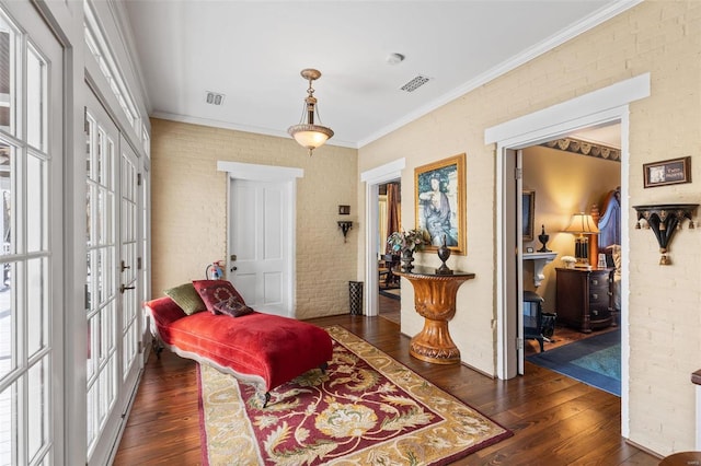813 S 4th St, Clarksville, MO 63336 - sitting room with dark wood-style floors, healthy amount of natural light, ornamental molding, and brick wall
