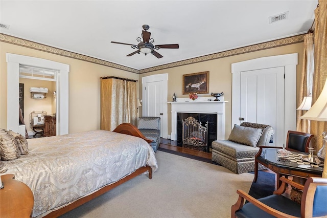813 S 4th St, Clarksville, MO 63336 - carpeted bedroom with a tiled fireplace and ceiling fan