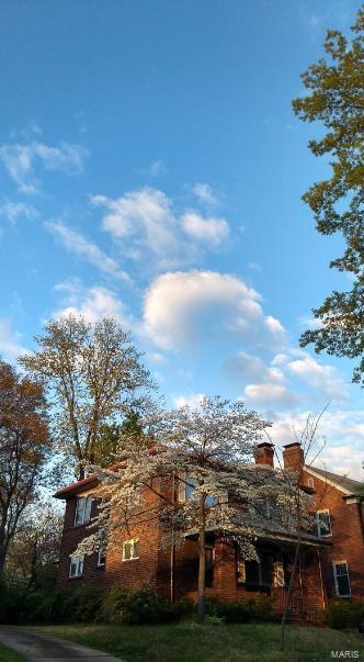 8245 Glen Echo Dr, Saint Louis, MO 63121 - view of front of property featuring a front yard and a chimney