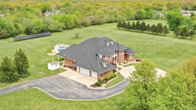 view from above of property with a heavily wooded area