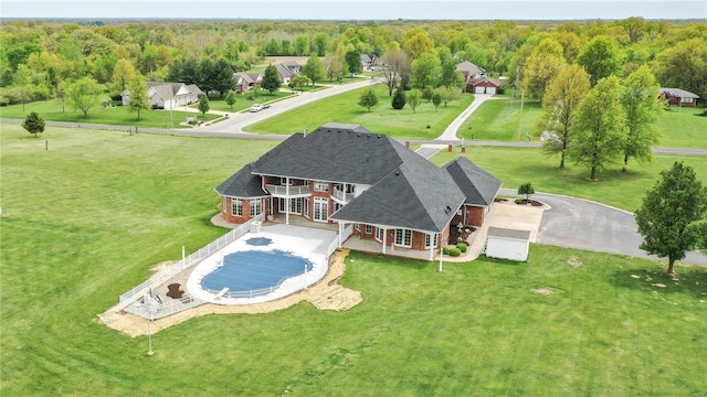 view of pool with a yard, french doors, and a wooded view