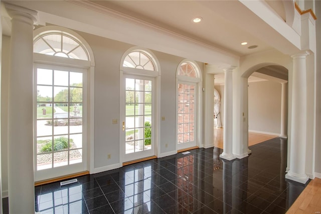 entryway with baseboards, plenty of natural light, decorative columns, recessed lighting, and crown molding