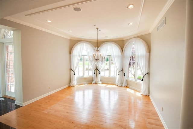 unfurnished dining area with hardwood / wood-style floors, a chandelier, baseboards, crown molding, and recessed lighting