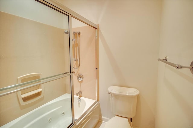 bathroom with toilet, a combined bath / shower with jetted tub, and baseboards