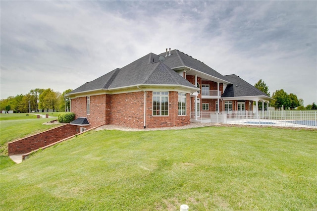 back of property featuring brick siding, roof with shingles, and a patio area