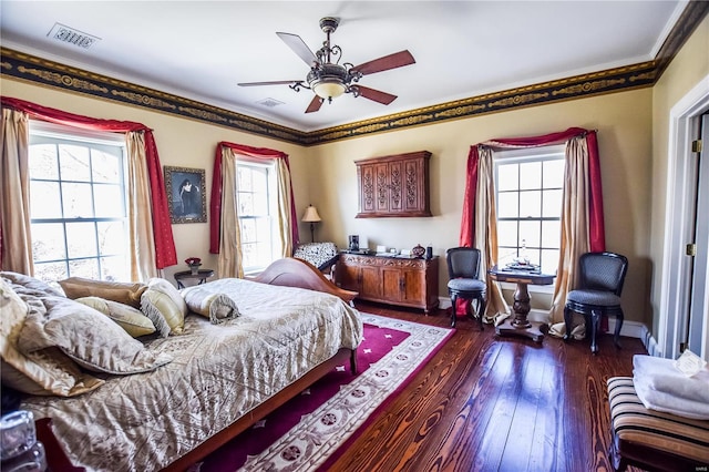 16093 Hwy W, Clarksville, MO 63336 - bedroom featuring multiple windows, dark wood finished floors, a ceiling fan, baseboards, and crown molding
