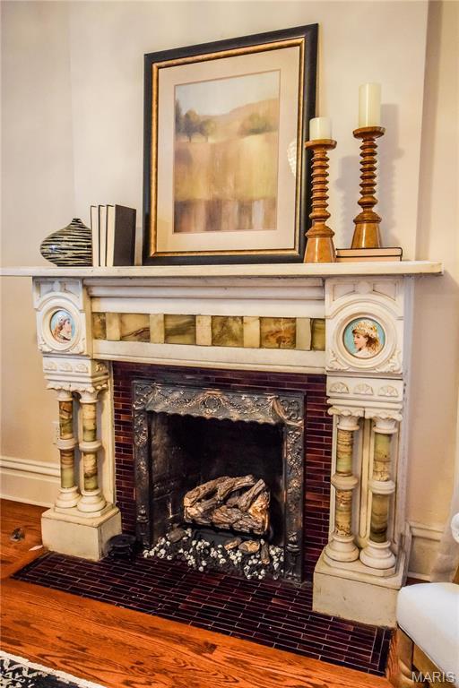 5076 Westminster Pl, Saint Louis, MO 63108 - detailed view of a tiled fireplace and wood finished floors