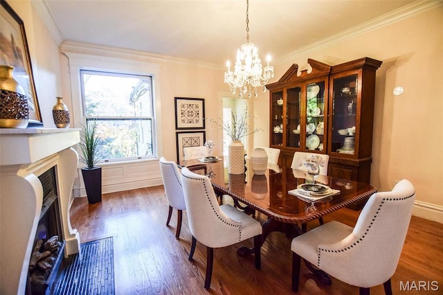 5076 Westminster Pl, Saint Louis, MO 63108 - dining space featuring a chandelier, a fireplace, dark wood-style floors, ornamental molding, and baseboards