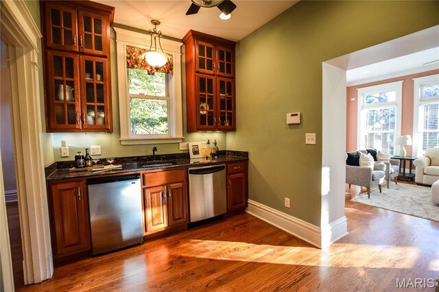 5076 Westminster Pl, Saint Louis, MO 63108 - kitchen featuring stainless steel dishwasher, a sink, dark wood finished floors, and baseboards
