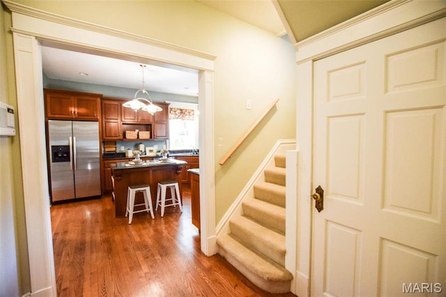 5076 Westminster Pl, Saint Louis, MO 63108 - stairway featuring wood finished floors and baseboards