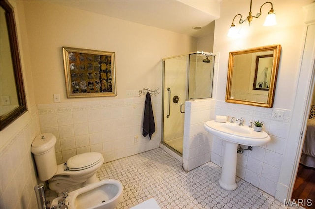 5076 Westminster Pl, Saint Louis, MO 63108 - full bathroom featuring tile walls, a bidet, a shower stall, toilet, and a wainscoted wall
