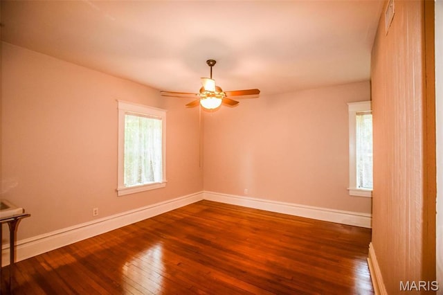 5076 Westminster Pl, Saint Louis, MO 63108 - empty room with wood-type flooring, a ceiling fan, and baseboards