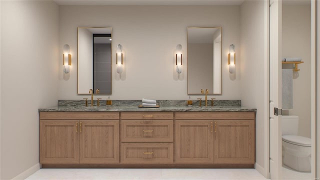 bathroom with toilet, double vanity, and baseboards